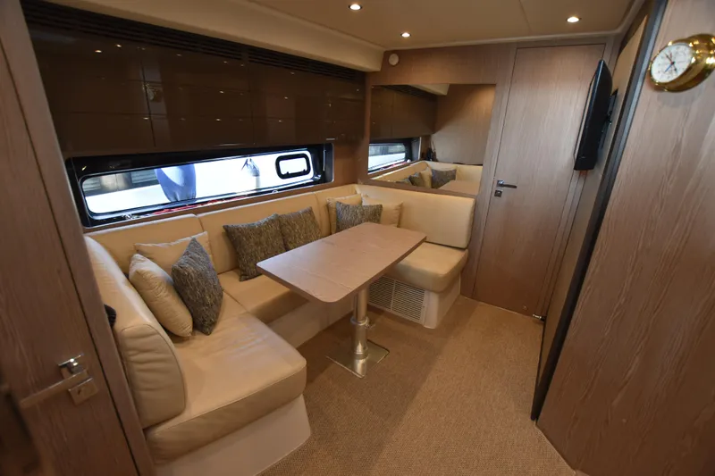 Vasanti Ll Yacht Photos Pics Luxurious interior of 2023 Azimut Atlantis 45 motor boat with elegant seating and wooden finishes.