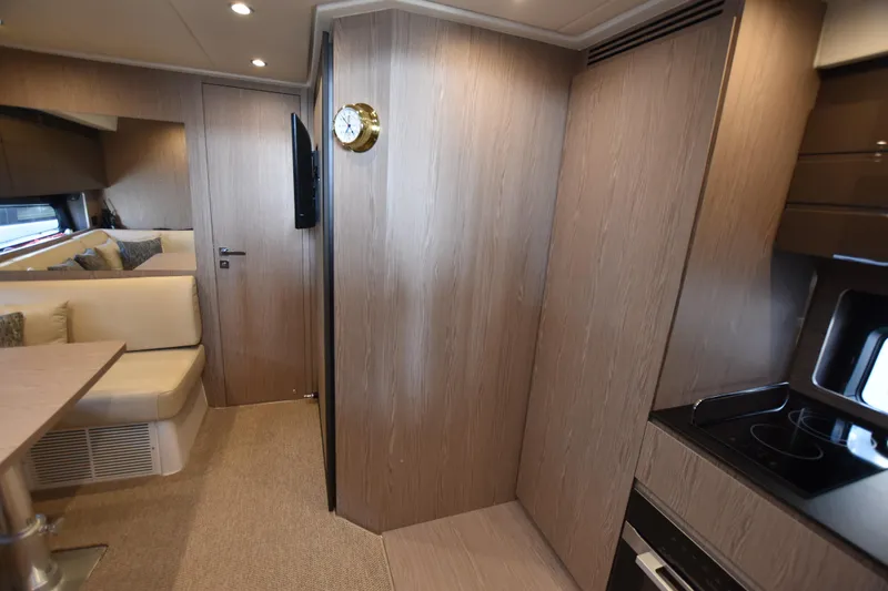 Vasanti Ll Yacht Photos Pics Spacious Luxurious interior of 2023 Azimut Atlantis 45 motor boat with modern wood finish and cozy seating.