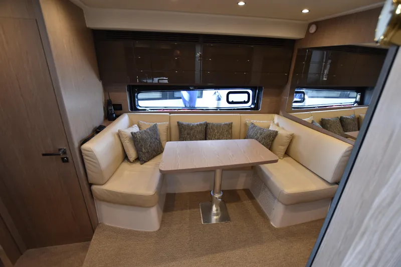 Vasanti Ll Yacht Photos Pics Luxurious spacious interior of 2023 Azimut Atlantis 45 motor boat with cozy seating and elegant table.