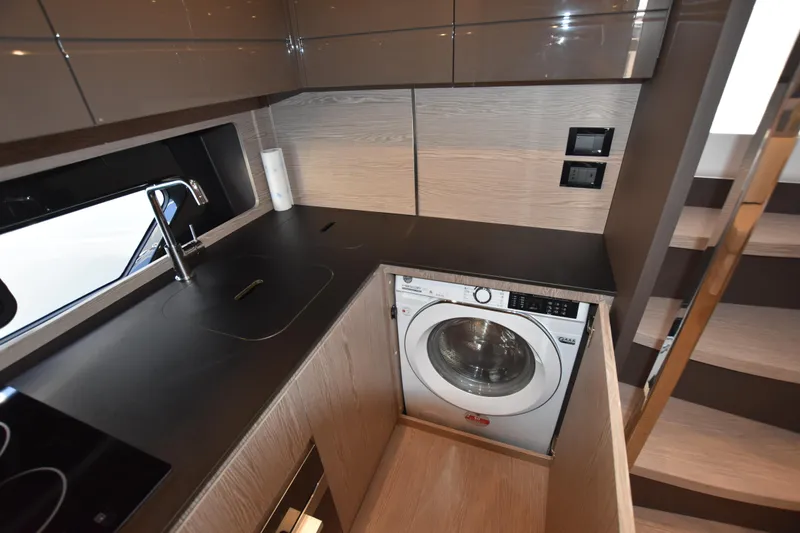 Vasanti Ll Yacht Photos Pics Modern kitchen in 2023 Azimut Atlantis 45 motor boat fully equipped with washer and sleek cabinetry.