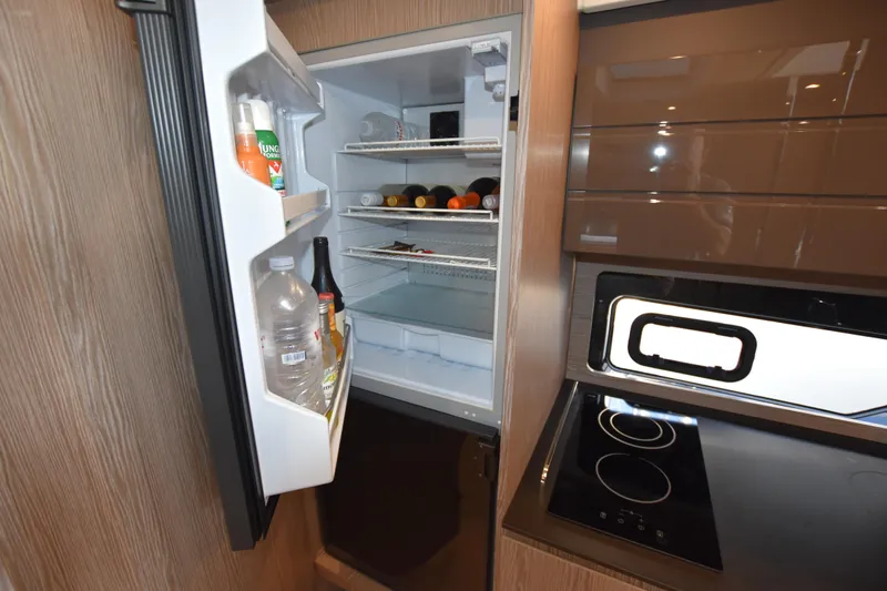 Vasanti Ll Yacht Photos Pics Fully equipped modern kitchen in 2023 Azimut Atlantis 45 motor boat with open fridge and stove.