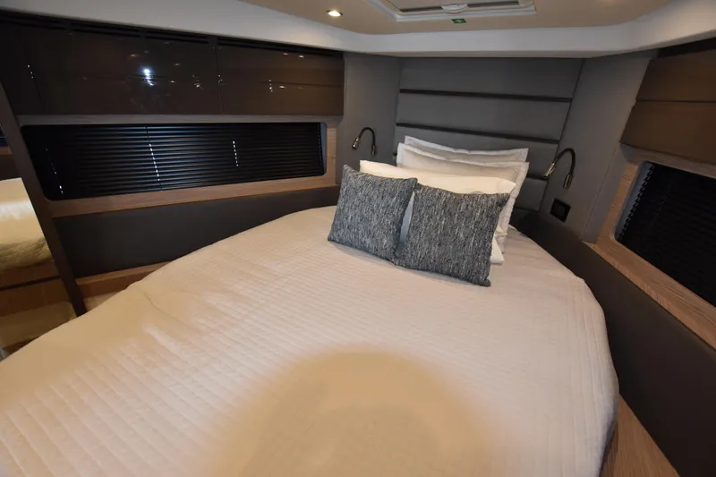 Vasanti Ll Yacht Photos Pics Luxurious bedroom interior of 2023 Azimut Atlantis 45 motor boat with modern design and cozy bedding.