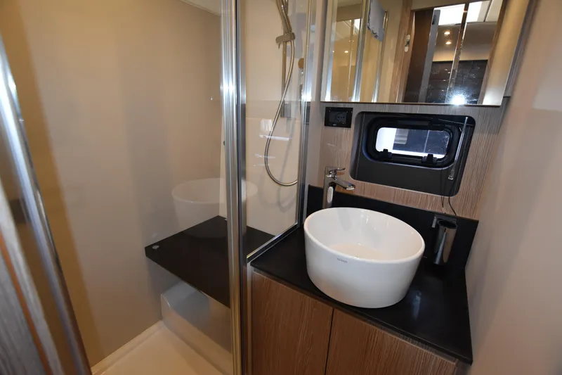 Vasanti Ll Yacht Photos Pics Luxurious bathroom in 2023 Azimut Atlantis 45 motor boat with modern fixtures and sleek design.