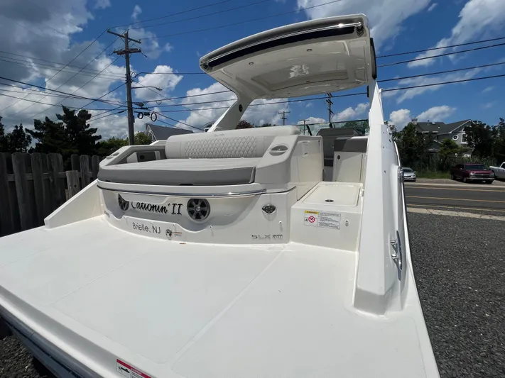  Yacht Photos Pics 2022 Sea Ray SLX 310 boat with spacious deck and seating, parked outdoors.