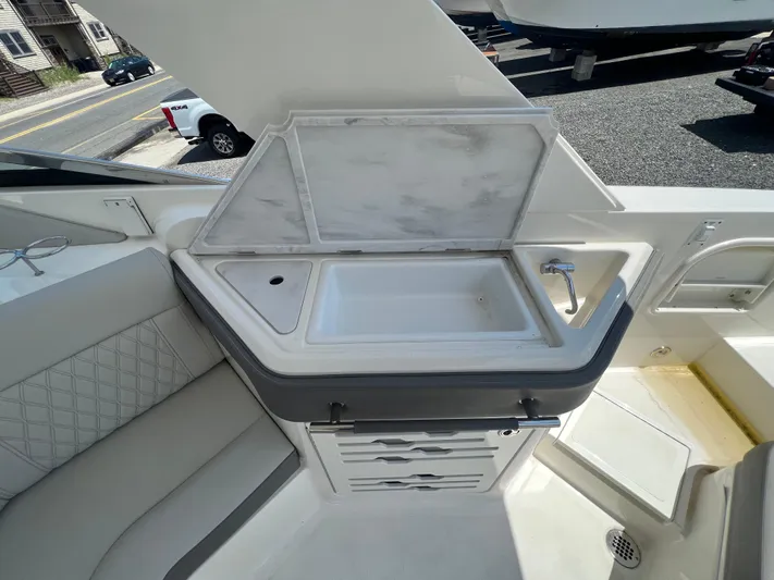  Yacht Photos Pics 2022 Sea Ray SLX 310 boat interior with sink and storage area.