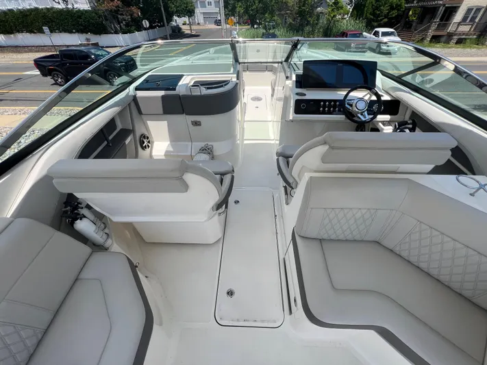  Yacht Photos Pics 2022 Sea Ray SLX 310 boat interior with modern seating and steering console.
