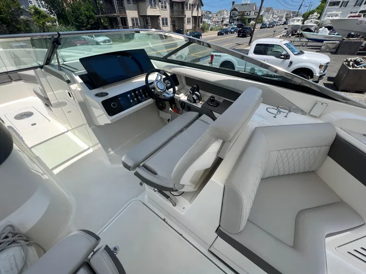  Yacht Photos Pics 2022 Sea Ray SLX 310 boat interior with modern dashboard and seating.