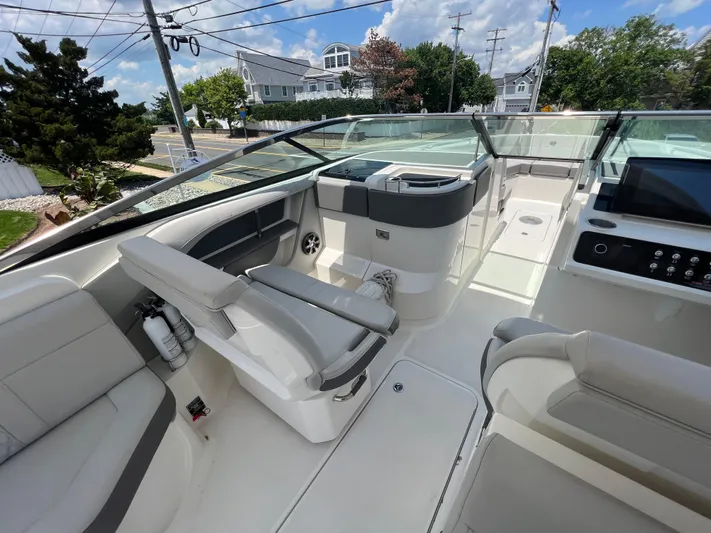  Yacht Photos Pics 2022 Sea Ray SLX 310 boat interior with modern seating and control panel.