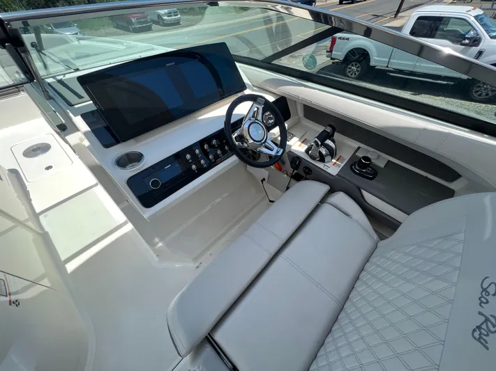  Yacht Photos Pics 2022 Sea Ray SLX 310 boat cockpit with modern steering and controls.