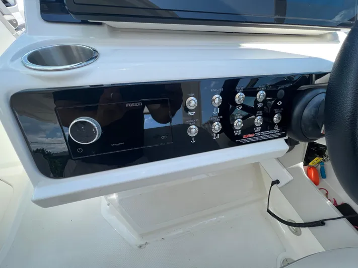  Yacht Photos Pics Control panel of 2022 Sea Ray SLX 310 boat with various switches and cup holder.