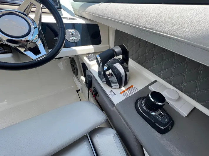  Yacht Photos Pics Interior of 2022 Sea Ray SLX 310 boat, featuring steering wheel and control panel.