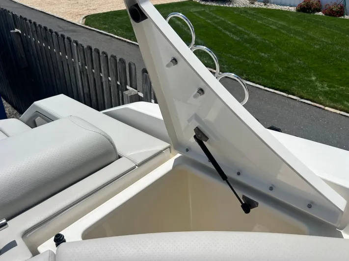  Yacht Photos Pics Open storage compartment on 2022 Sea Ray SLX 310 boat, showcasing sleek design and functionality.