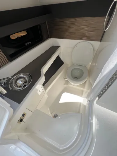  Yacht Photos Pics 2022 Sea Ray SLX 310 boat bathroom with sink and toilet.