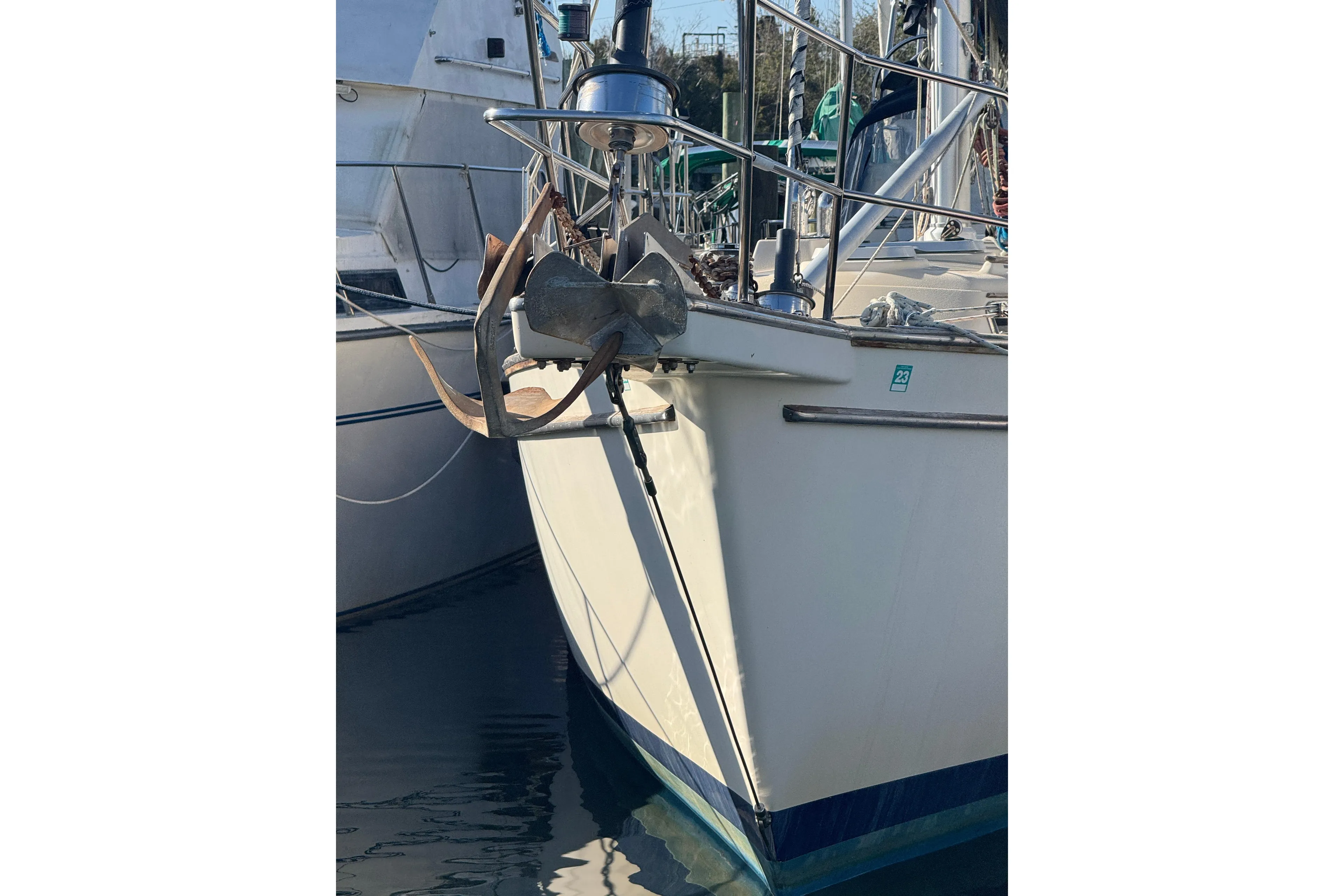 Bow of 1991 Island Packet Yachts 38 with anchor, docked in marina.