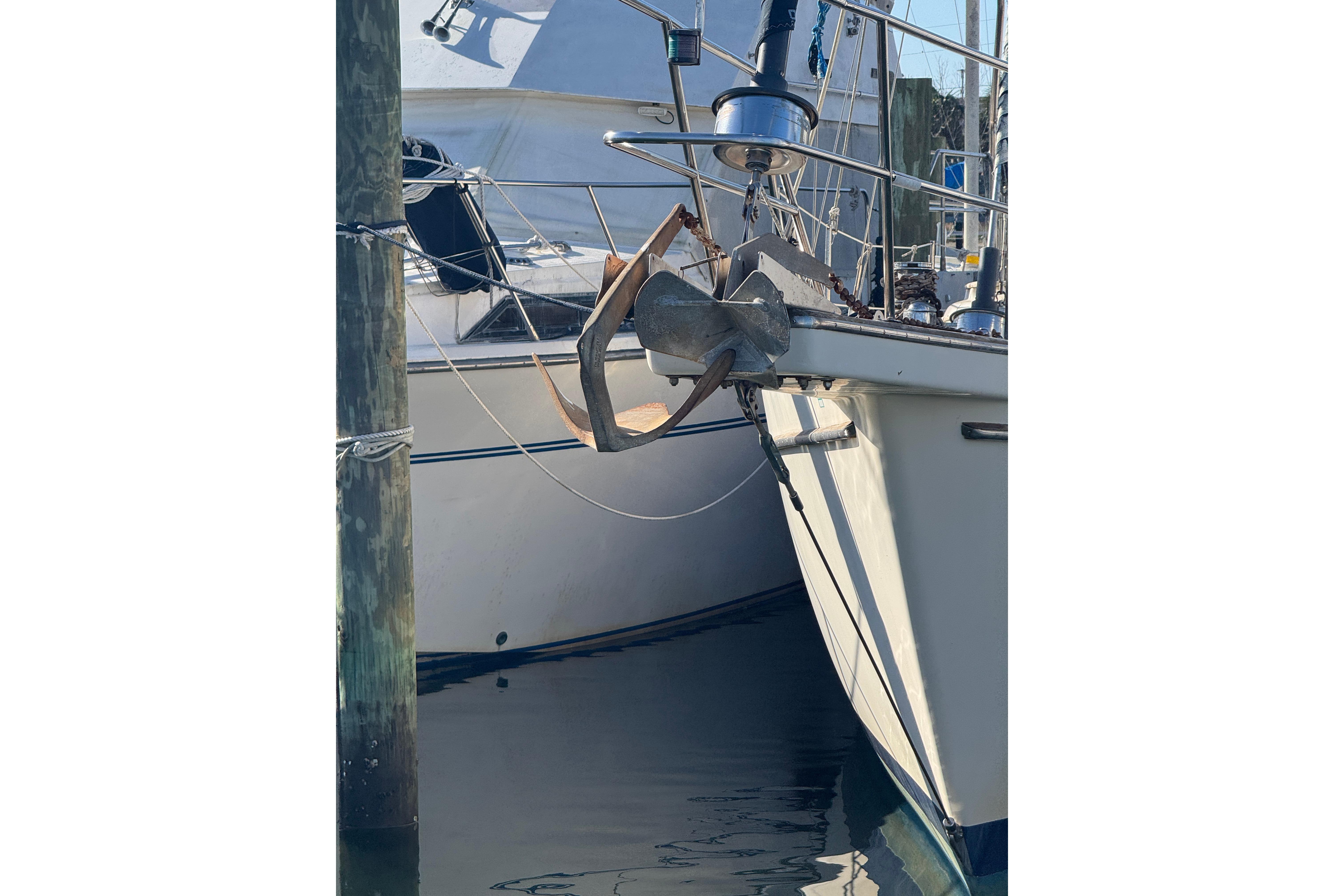 1991 Island Packet Yachts 38 sailboat with anchor at marina dock.