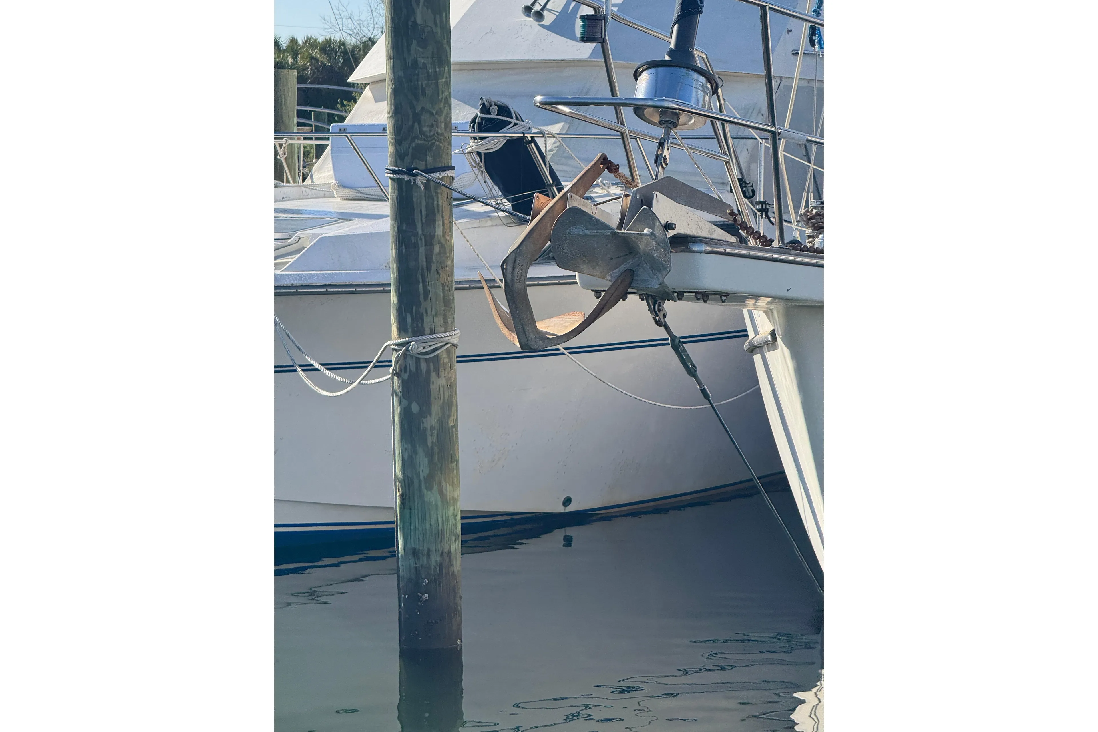 1991 Island Packet Yachts 38 anchored at a marina, showcasing its sturdy bow design.