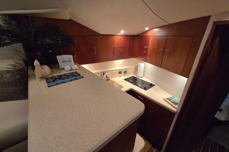  Yacht Photos Pics Luxurious 1999 Ocean Yachts 40 Open galley with modern amenities and elegant wood cabinetry.