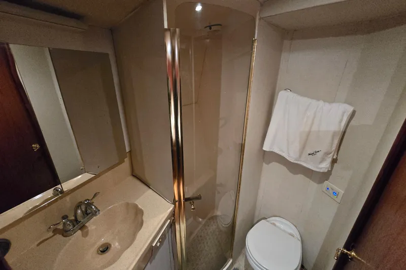  Yacht Photos Pics Bathroom interior of 1999 Ocean Yachts 40 Open, featuring shower, sink, and toilet.