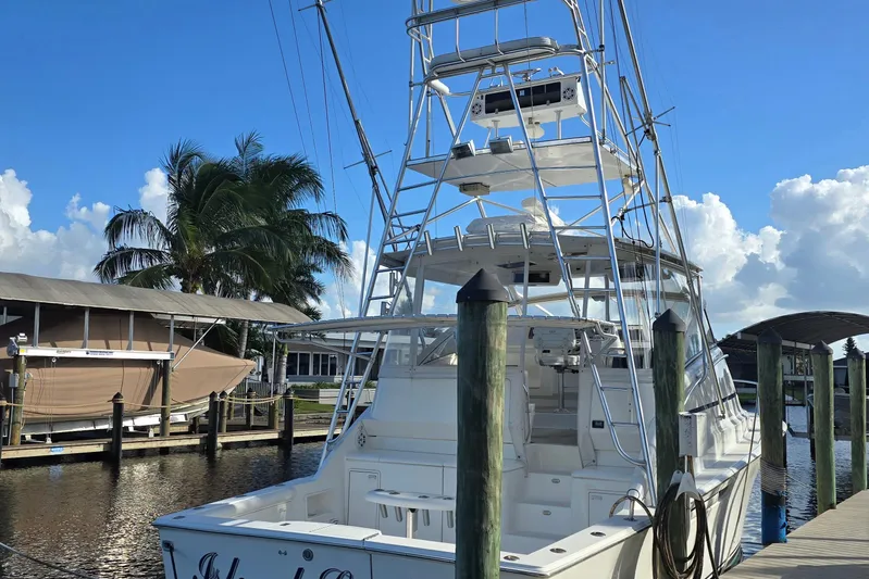  Yacht Photos Pics 1999 Ocean Yachts 40 Open docked, featuring a tall tower and clear blue sky backdrop.