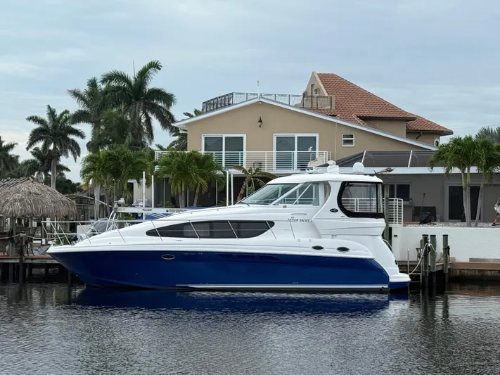  Yacht Photos Pics 2006 Sea Ray 40 Motor Yacht docked by a waterfront home with palm trees.
