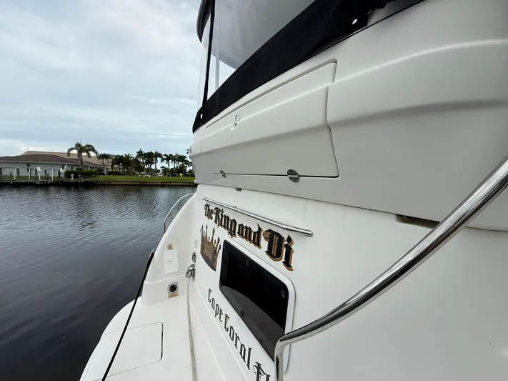  Yacht Photos Pics 2006 Sea Ray 40 Motor Yacht docked by waterfront homes, overcast sky.