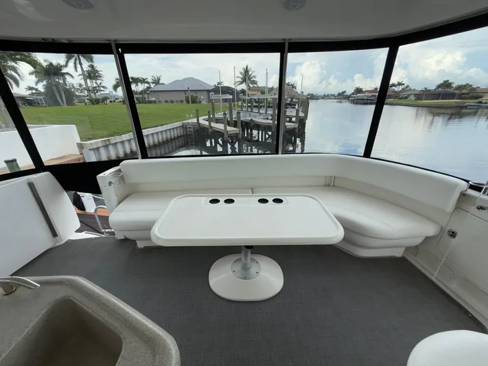  Yacht Photos Pics Interior of 2006 Sea Ray 40 Motor Yacht with white seating and table, overlooking marina.