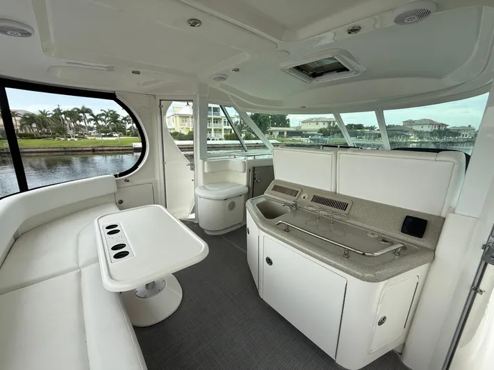  Yacht Photos Pics 2006 Sea Ray 40 Motor Yacht interior with seating, table, and kitchenette by the water.