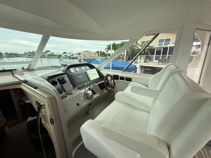  Yacht Photos Pics 2006 Sea Ray 40 Motor Yacht helm with white seating and modern controls.