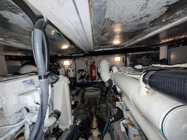  Yacht Photos Pics Engine room of a 2006 Sea Ray 40 Motor Yacht, showcasing mechanical components and piping.