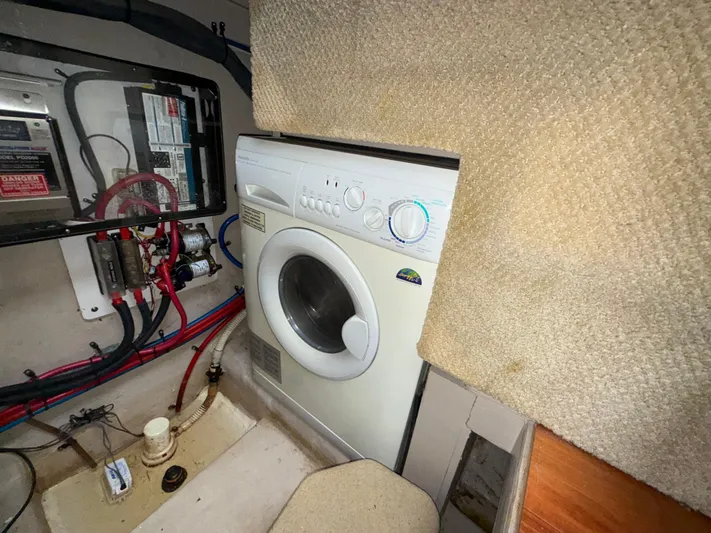  Yacht Photos Pics Laundry area inside 2006 Sea Ray 40 Motor Yacht with washing machine and electrical panel.