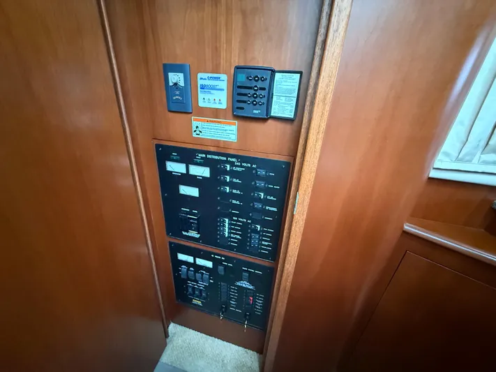  Yacht Photos Pics Electrical control panel inside 2006 Sea Ray 40 Motor Yacht, featuring wood paneling.