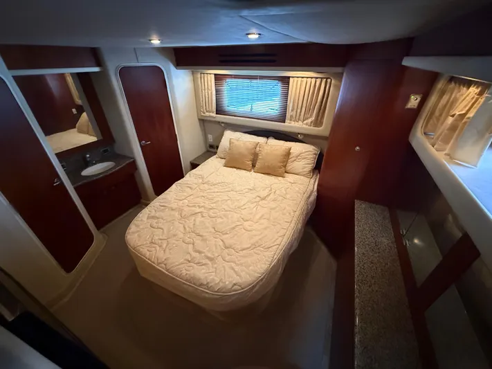  Yacht Photos Pics Luxurious bedroom interior of 2006 Sea Ray 40 Motor Yacht with cozy bed and elegant decor.