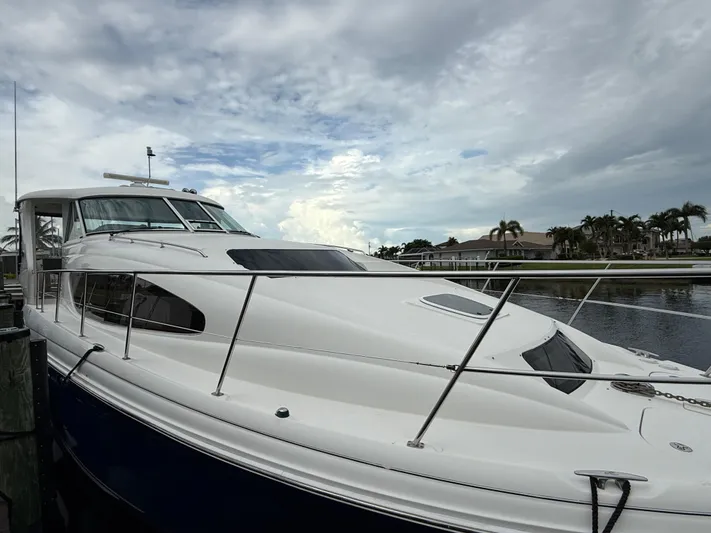  Yacht Photos Pics 2006 Sea Ray 40 Motor Yacht docked under cloudy sky, showcasing sleek design and spacious deck.