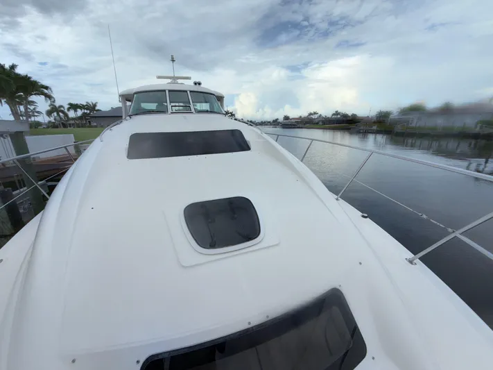  Yacht Photos Pics 2006 Sea Ray 40 Motor Yacht on calm water under cloudy sky.