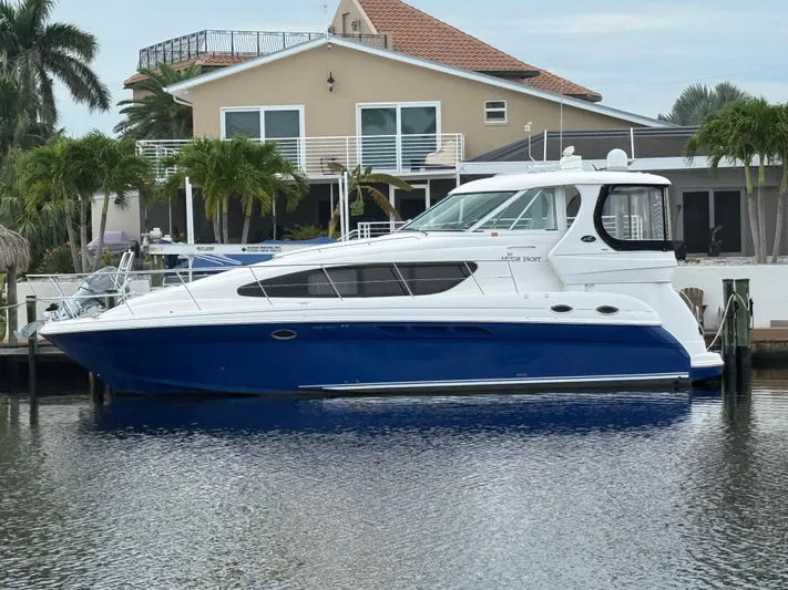  Yacht Photos Pics 2006 Sea Ray 40 Motor Yacht docked by a waterfront home with palm trees.