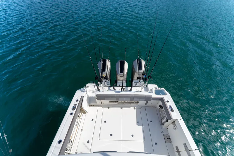 Fast Kash Yacht Photos Pics 2023 Boston Whaler 420 Outrage boat with fishing rods on open water.