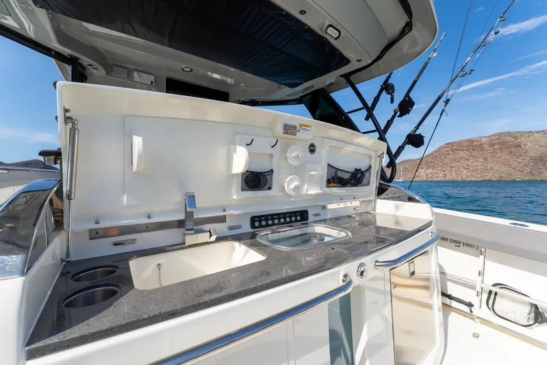 Fast Kash Yacht Photos Pics 2023 Boston Whaler 420 Outrage boat with sleek outdoor kitchen setup.