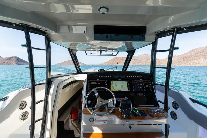 Fast Kash Yacht Photos Pics 2023 Boston Whaler 420 Outrage helm with advanced navigation system on open water.