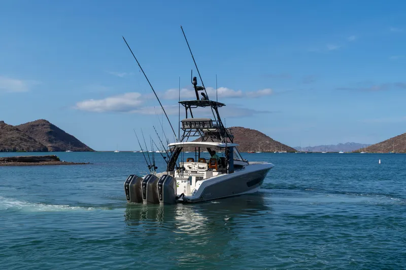 Fast Kash Yacht Photos Pics 2023 Boston Whaler 420 Outrage boat cruising in scenic coastal waters.