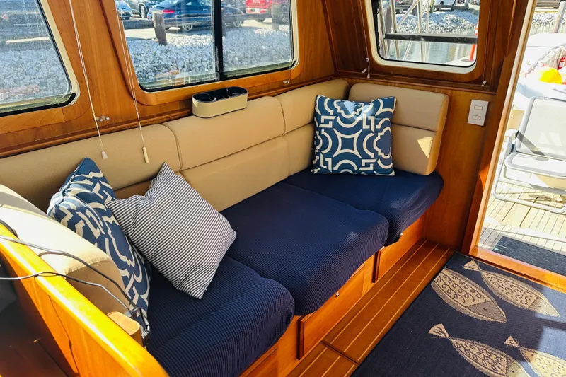 No Rush Yacht Photos Pics Cozy interior of 2006 Sabre 42 Fly Bridge with stylish cushions and wooden accents.