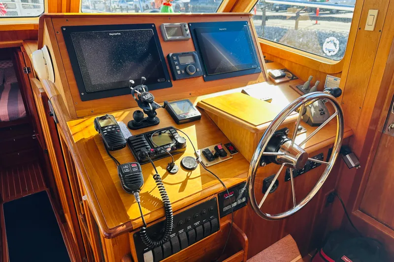 No Rush Yacht Photos Pics Helm of 2006 Sabre 42 Fly Bridge with navigation equipment and steering wheel.