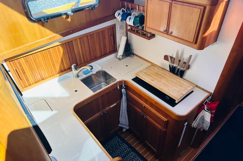 No Rush Yacht Photos Pics 2006 Sabre 42 Fly Bridge yacht kitchen with wooden cabinets and countertop.