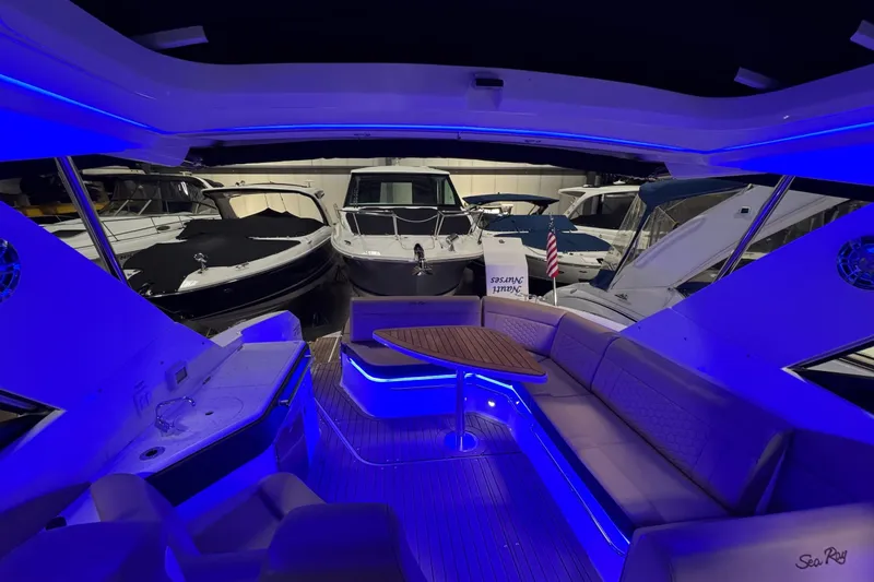  Yacht Photos Pics 2021 Sea Ray Sundancer 320 interior with blue LED lighting, docked among other boats.