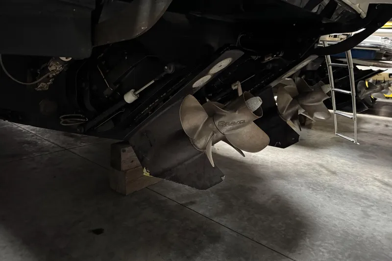  Yacht Photos Pics Propellers of a 2021 Sea Ray Sundancer 320 boat in a garage setting.