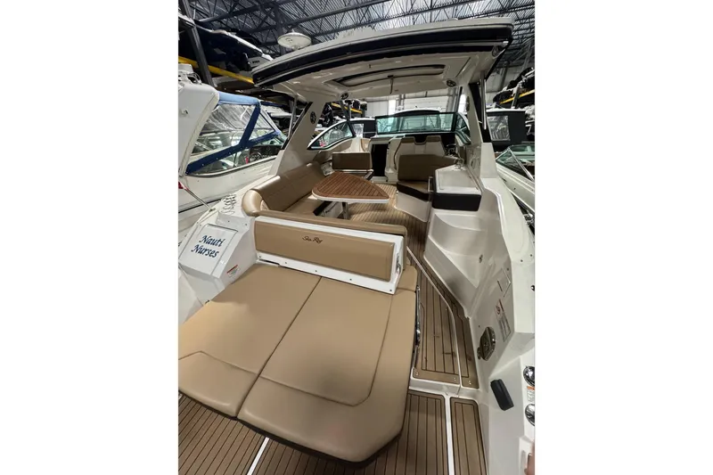  Yacht Photos Pics 2021 Sea Ray Sundancer 320 interior with tan seating and wooden flooring.