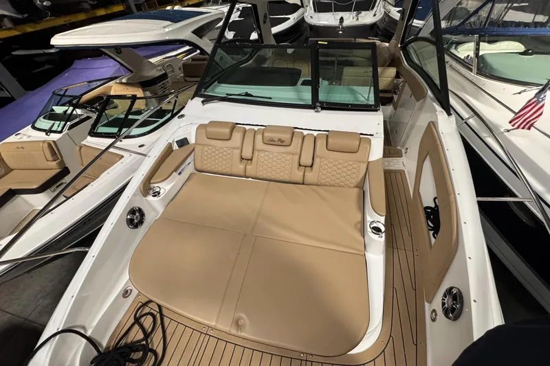  Yacht Photos Pics 2021 Sea Ray Sundancer 320 boat with tan seating and sleek design in a showroom.