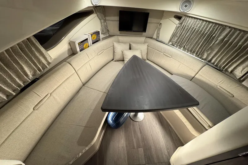  Yacht Photos Pics Luxurious interior of 2021 Sea Ray Sundancer 320 with plush seating and modern table.