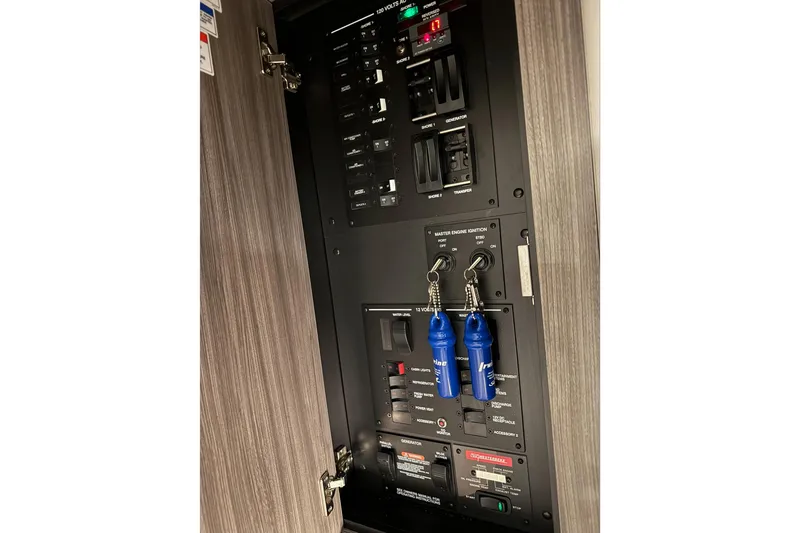  Yacht Photos Pics Control panel of a 2021 Sea Ray Sundancer 320 boat with switches and keys.