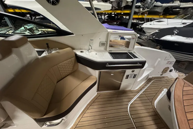 Yacht Photos Pics 2021 Sea Ray Sundancer 320 interior with seating and kitchenette on teak deck.