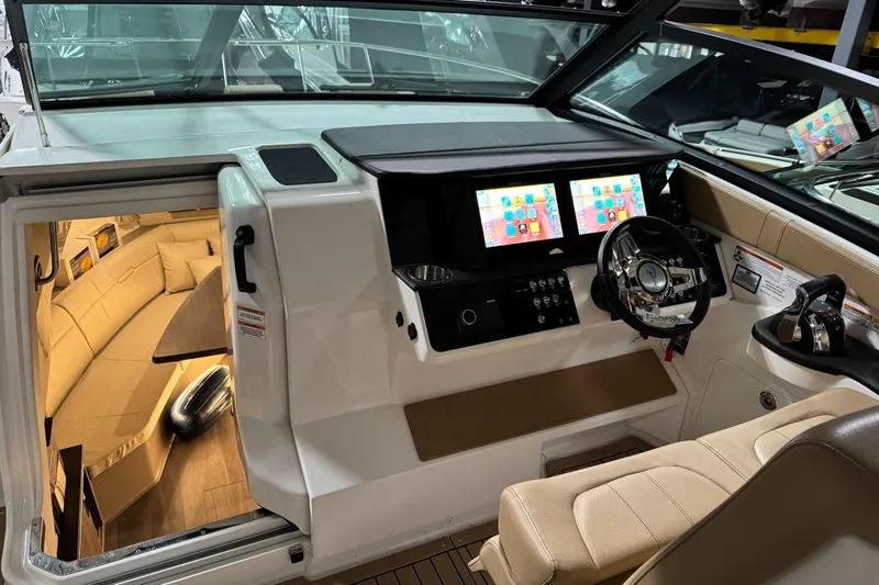  Yacht Photos Pics 2021 Sea Ray Sundancer 320 cockpit with dual screens and luxurious interior seating.